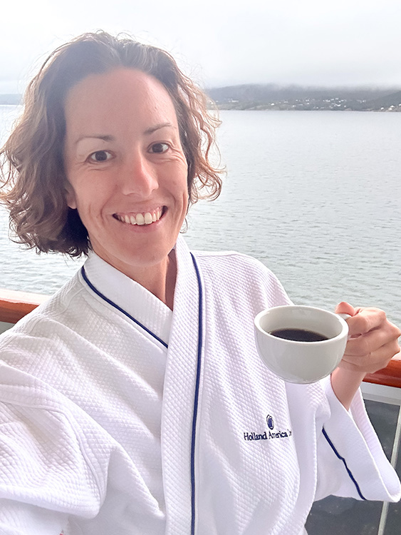 Ashley Wali enjoying a cup of coffee on the balcony outside her Verandah Stateroom on board the Holland America Line MS Rotterdam.
