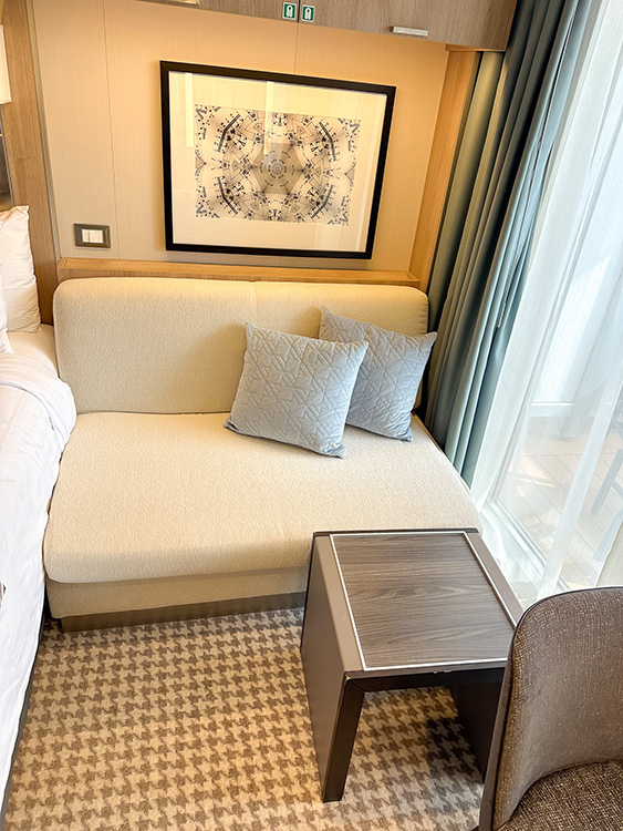 A comfortable seating area in a Verandah Stateroom on board the Holland America Line MS Rotterdam.