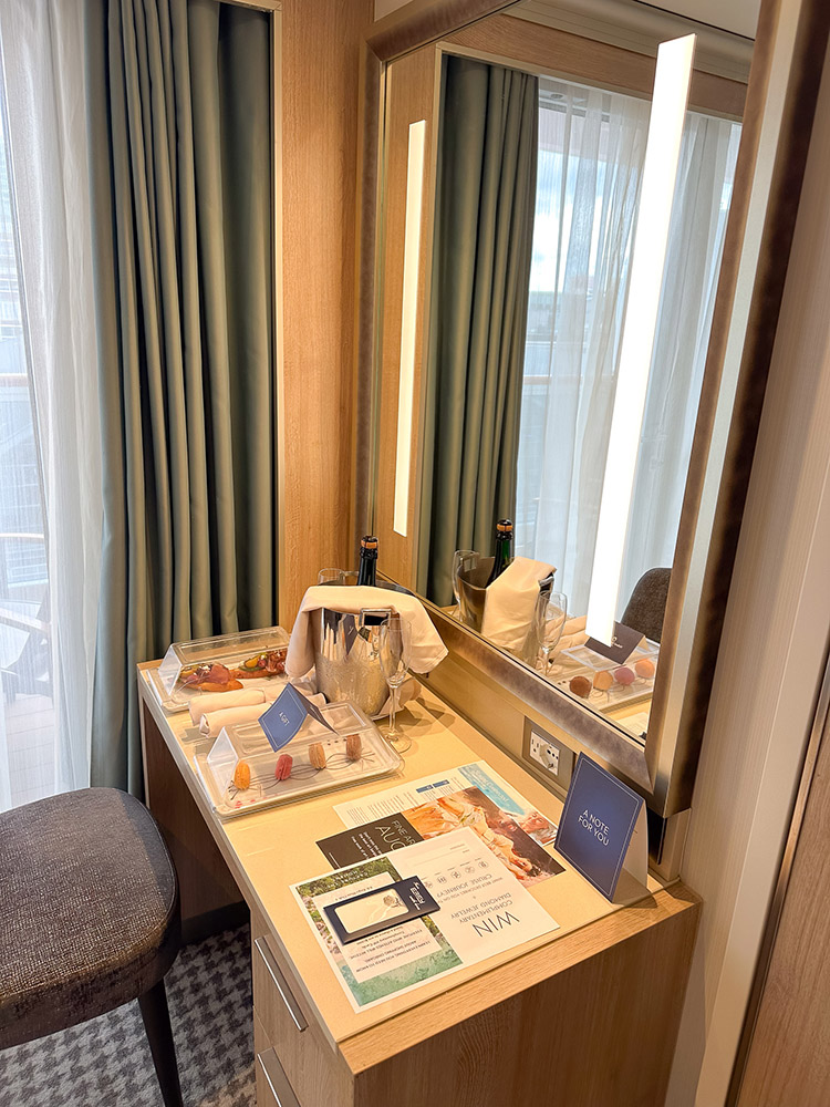 Welcome amenities on the desk in a Verandah Stateroom on board the Holland America Line MS Rotterdam.