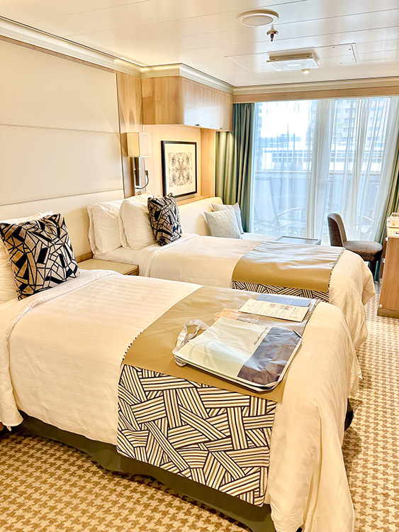 Comfortable beds in a Verandah Stateroom on board the Holland America Line MS Rotterdam.