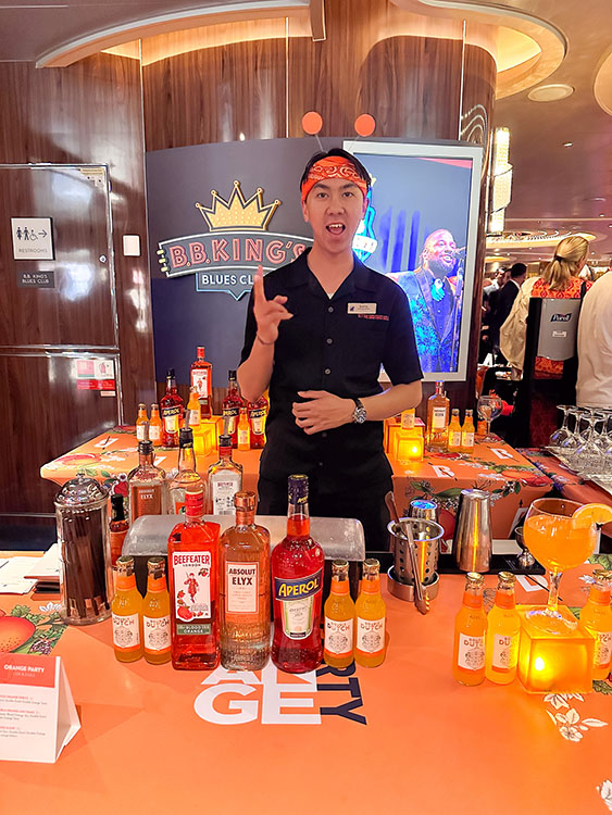 A bartender preparing orange cocktails at the Orange Party on board the Holland America Line MS Rotterdam.