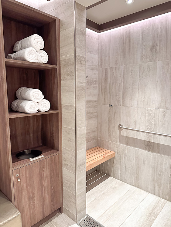 A shower room and towels in the Greenhouse Spa & Salon on the Holland America Line MS Rotterdam.