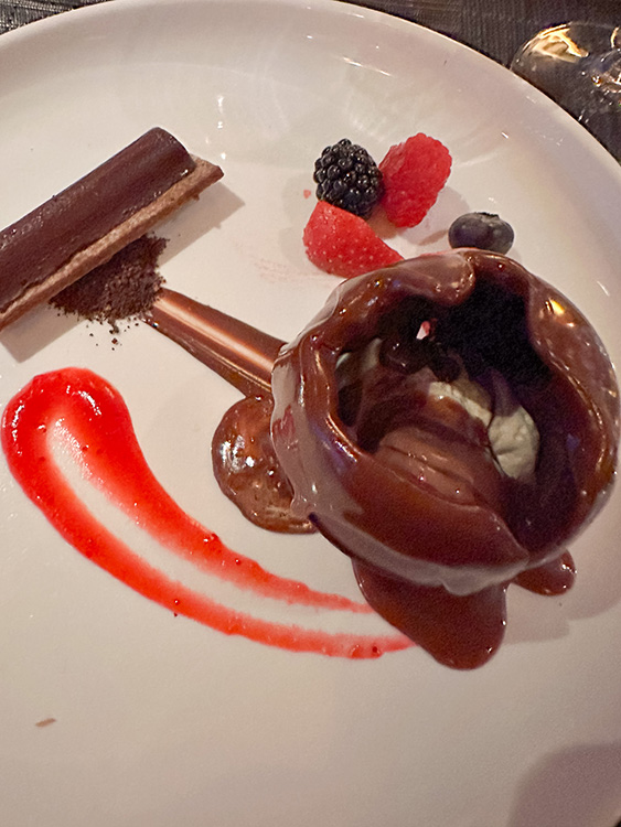A chocolate sphere dessert served at Morimoto by Sea, a restaurant on board the MS Rotterdam.