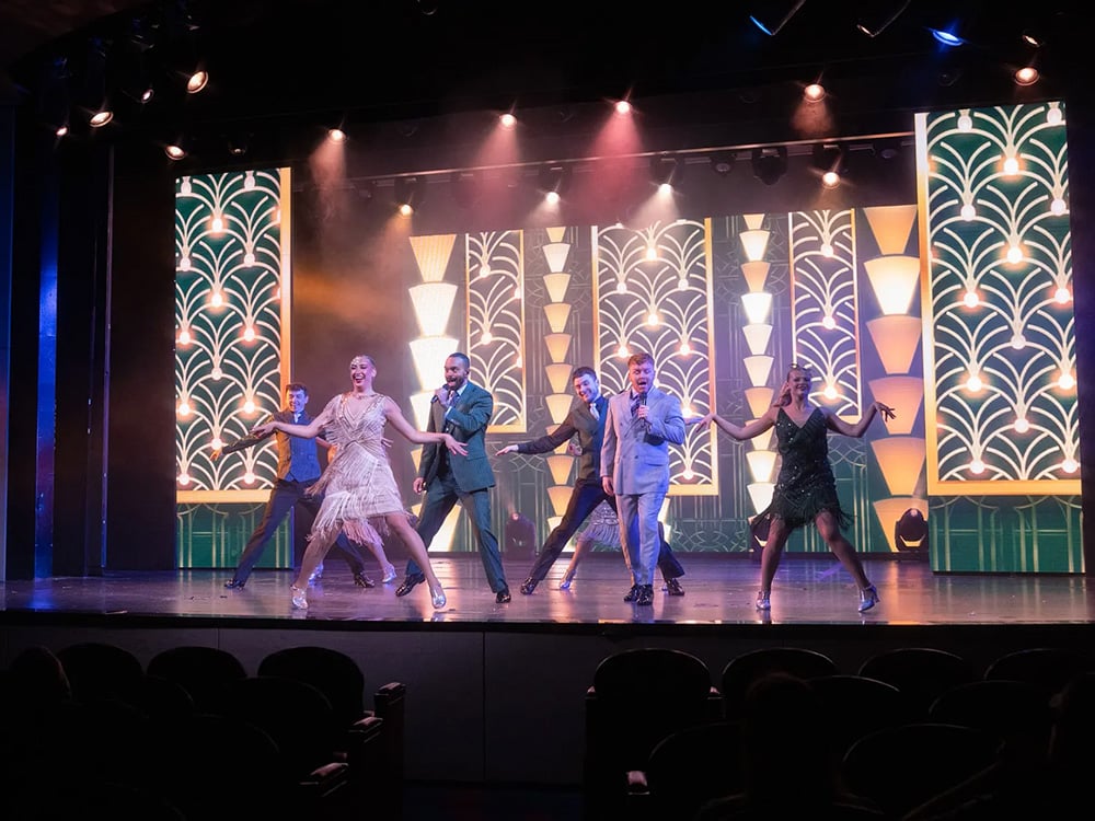 Entertainers sing and dance on stage during the MS Rotterdam's Welcome Aboard show.