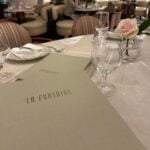 View of the menu and table setting at La Fontaine restaurant in the Fontainebleau Las Vegas hotel.