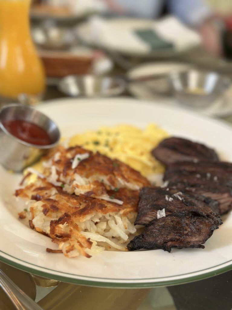 A plate of steak and eggs served with a hash brown. Part of brunch at the Garden Table at the Bellagio, Las Vegas.