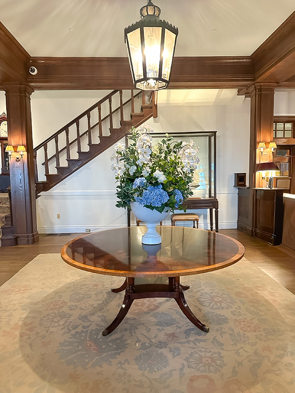 A large floral display on a round wooden table in the elegant lobby of the Chatham Bars Inn, Cape Cod, MA.