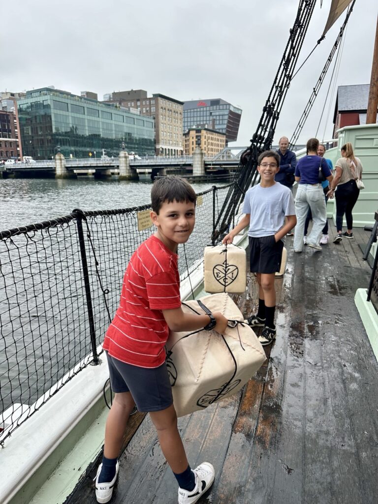 Ashley Wali's sons prepare to throw replica tea chests into the harbor at the Boston Tea Party Museum in Boston, Massachusetts.