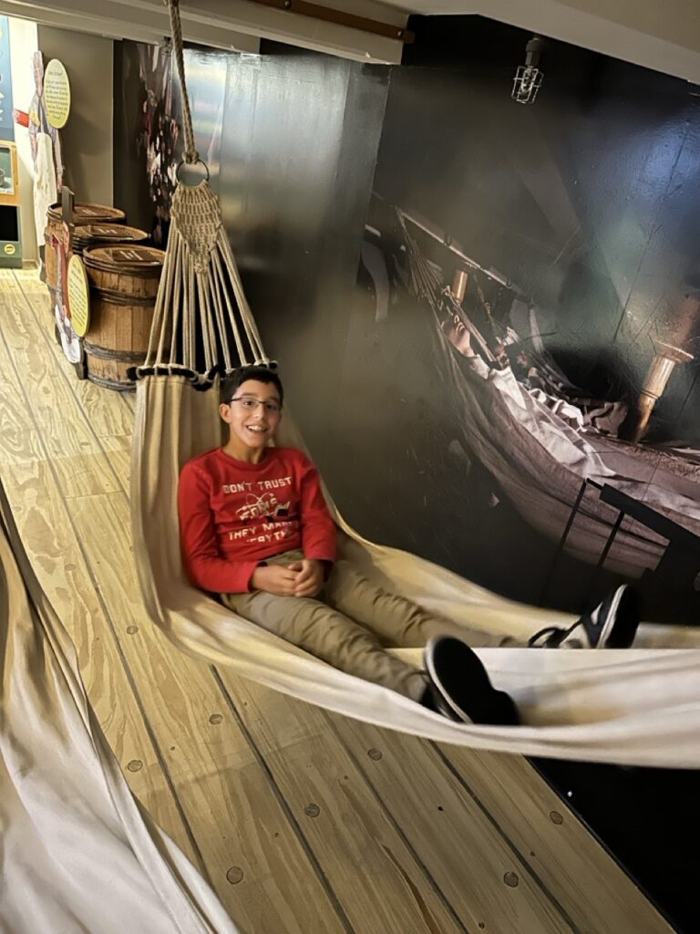 Ashley Wali's son reclines in a hammock on board the USS Constitution in Boston, Massachusetts.