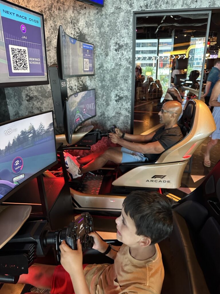 Playing racing games at the F1 arcade in Boston, Massachusetts.