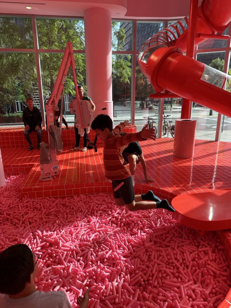 Ashley Wali's son jumps enthusiastically into the Sprinkle Pit at the Museum of Ice Cream in Boston, Massachusetts.