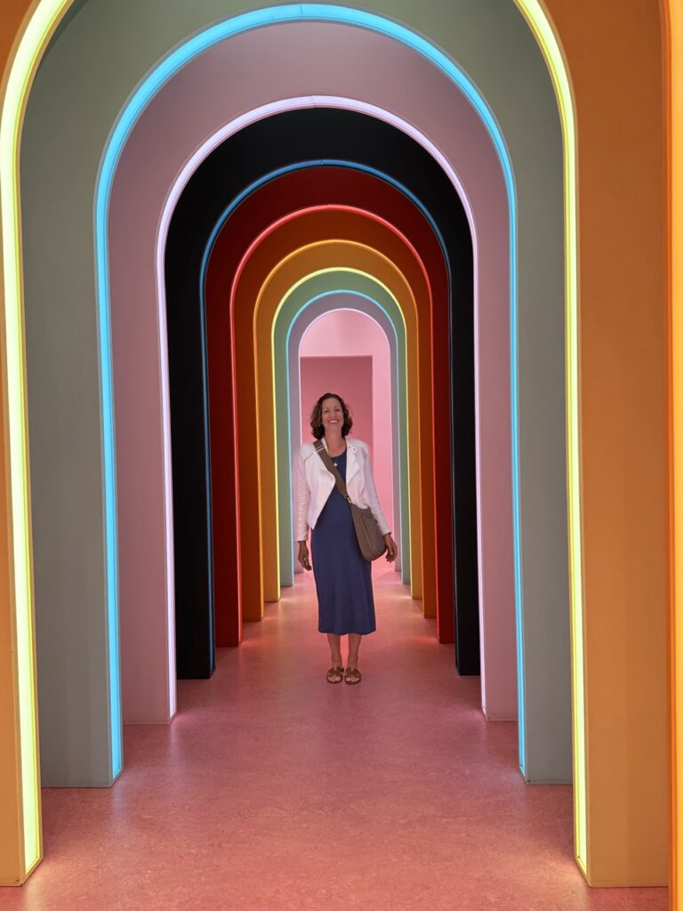 Ashley Wai stands in a colorful tunnel at the Museum of Ice Cream in Boston, Massachusetts.