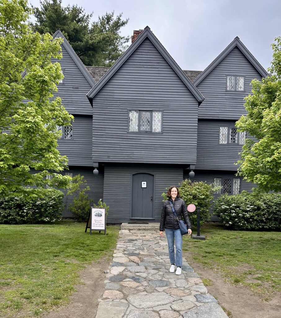 Ashley Wali stands outside Salem Witch House near Boston, Massachusetts.