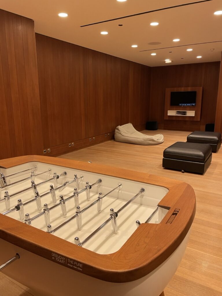 Comfortable seating and a foosball table in the Qatar Airways Al Mourjan Business Lounge at Doha’s Hamad International Airport