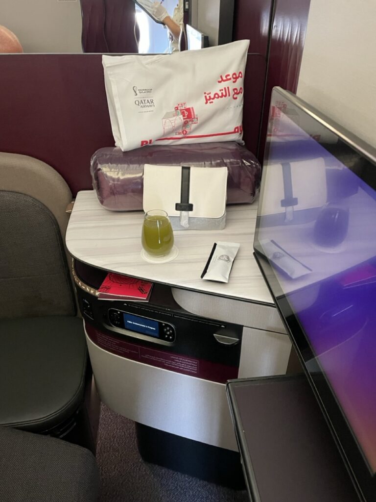 Amenities and entertainment system in the Business Class Q-Suite on board a Qatar Airways flight.