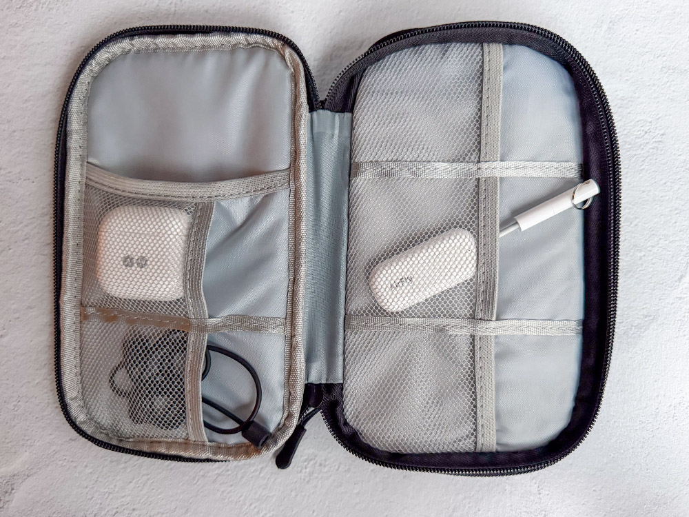 FYY Travel cable organizer with various travel tech inside.