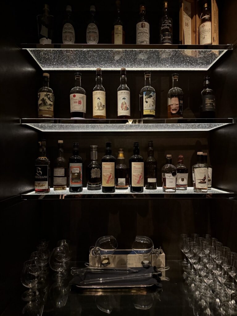 A selection of whisky bottles on shelves at DarkSide cocktail bar, Hong Kong.