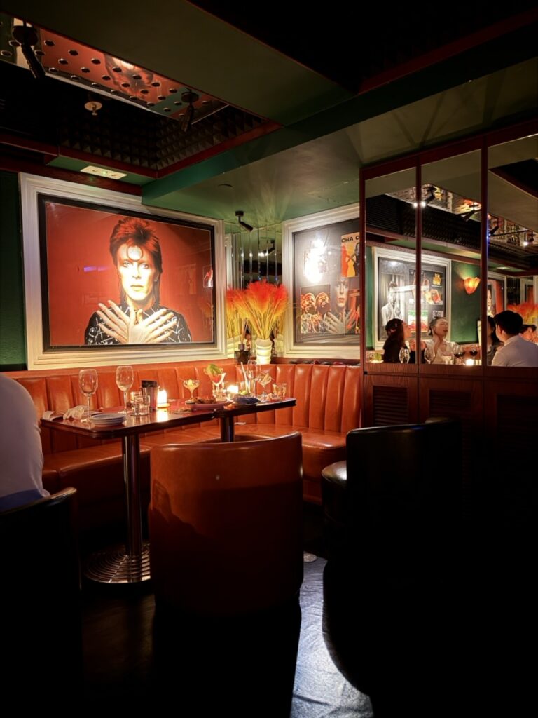 A large portrait of David Bowie is displayed above stylish leather seating in Bar Montana, Hong Kong.