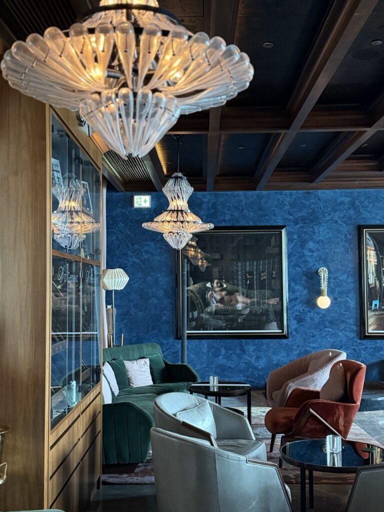 Dramatic glass chandeliers and rich colors in the decor at XX bar, Hong Kong.