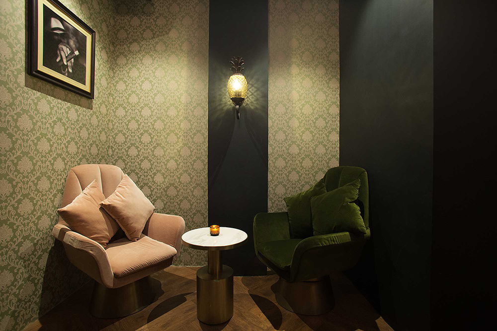 Plush velvet seating and elegant decor at The Old Man bar, Hong Kong.