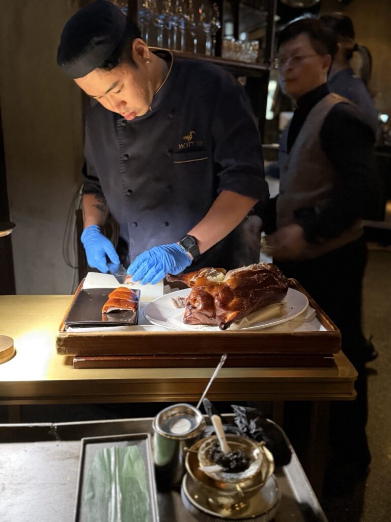 Chefs preparing Peking duck tableside at Mott 32 restaurant, Hong Kong.