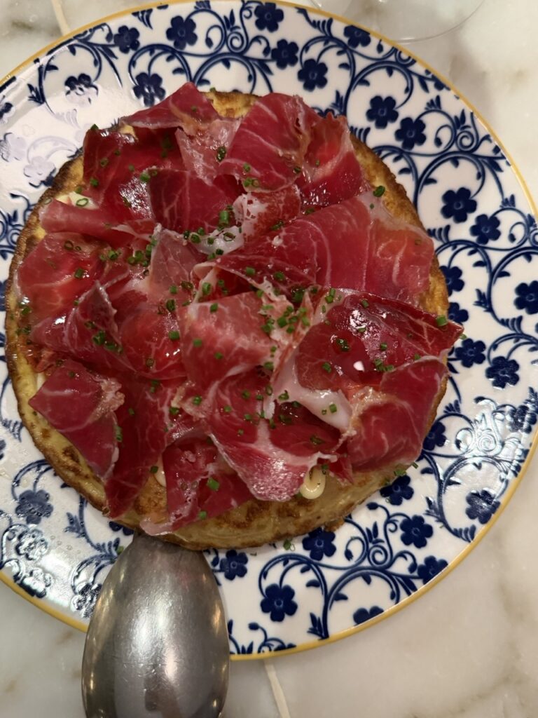 A tortilla de patatas topped with sliced jamon at Bayfare Social restaurant, Hong Kong.