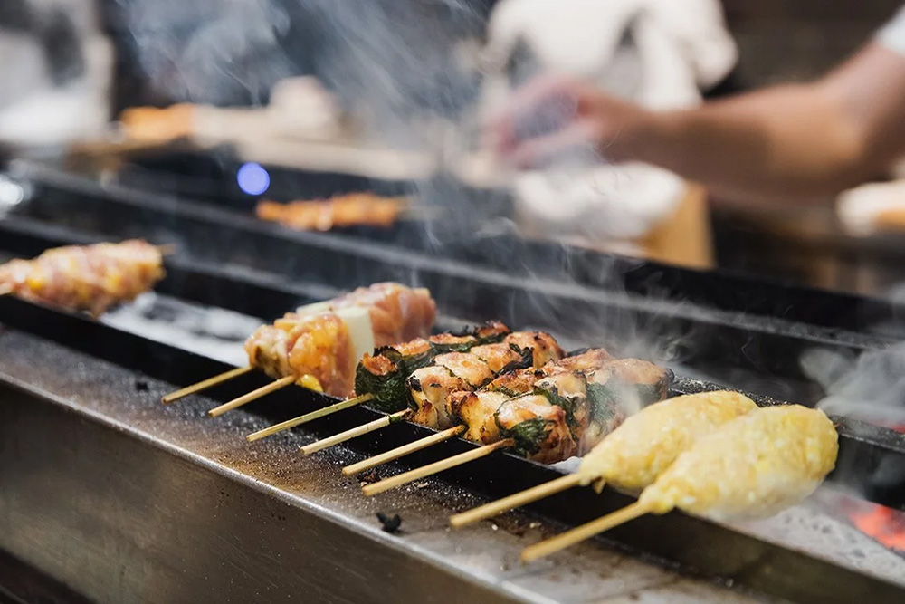 Chicken yakitori skewers on the grill at Yardbird, Hong Kong.